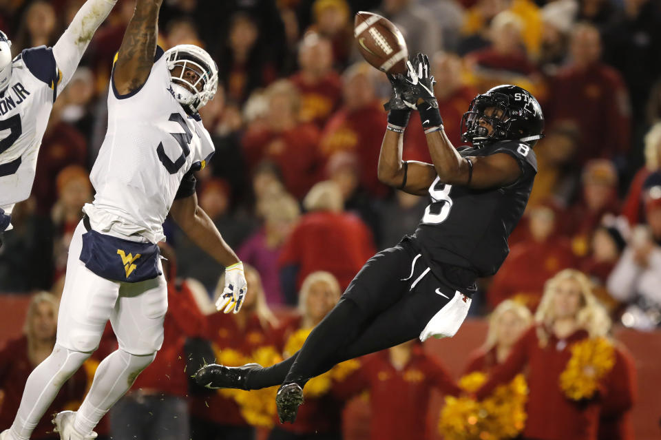 Iowa State wide receiver Deshaunte Jones, right, catches a 32-yard touchdown pass in front of West Virginia safety Toyous Avery Jr. (3) during the second half of an NCAA college football game, Saturday, Oct. 13, 2018, in Ames, Iowa. (AP Photo/Charlie Neibergall)