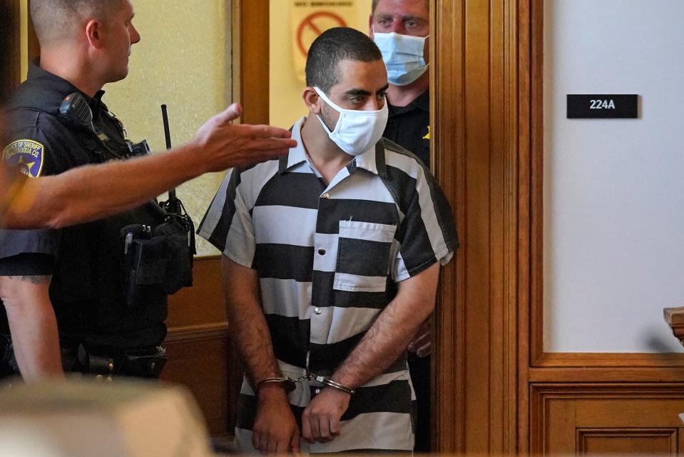 Hadi Matar, 24, center, arrives for an arraignment in the Chautauqua County Courthouse in Mayville, NY., Saturday, Aug. 13, 2022. (AP Photo/Gene J. Puskar) ORG XMIT: NYGP101