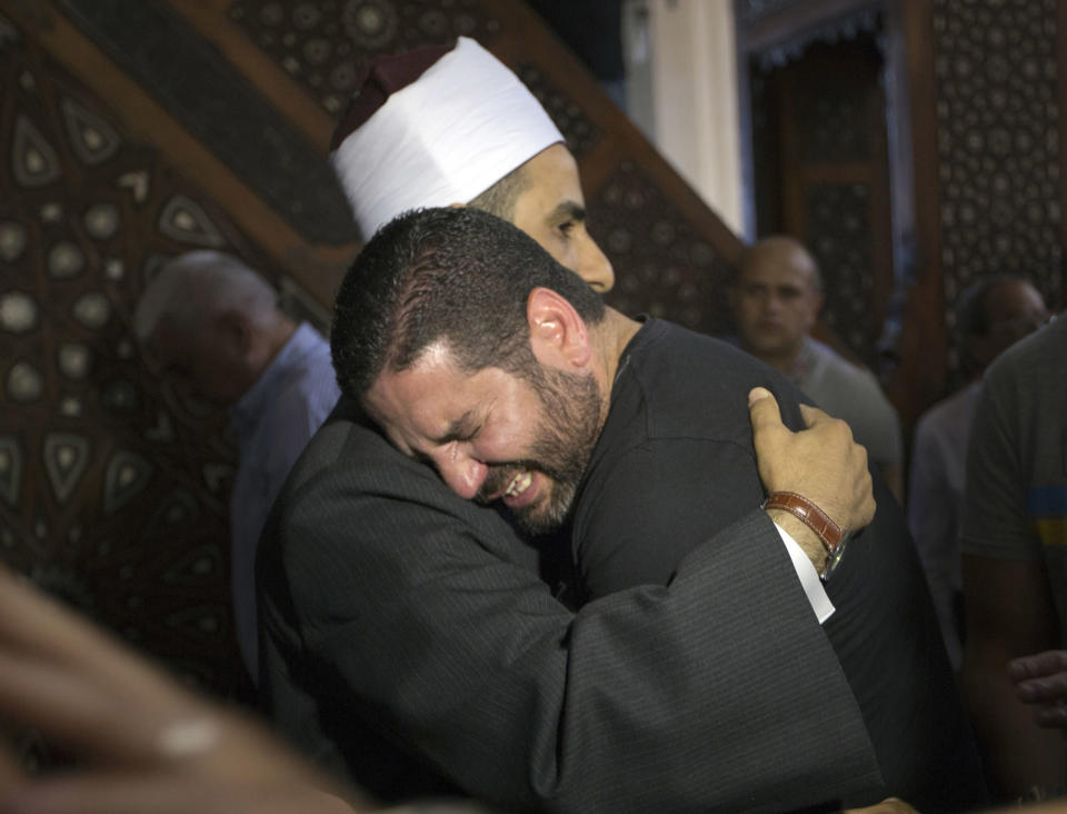 <p>The Imam of al Thawrah Mosque, Samir Abdel Bary, gives condolences to film director Osman Abu Laban, center, who lost four relatives, all victims of Thursday’s EgyptAir plane crash, following prayers for the dead, at al Thawrah Mosque, in Cairo, Egypt, May 20, 2016. The Airbus A320 plane was flying from Paris to Cairo when it disappeared early Thursday over the sea. (Amr Nabil/AP) </p>