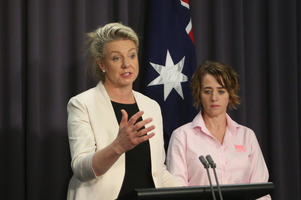 Australian Agriculture Minister Bridget McKenzie, left, and pork industry executive Margo Andrae address the media at Parliament House in Canberra, Australia Tuesday, Oct. 15, 2019, on the threat of African swine fever. Australia for the first time has canceled a tourist's visa over undeclared food as the country tries to keep itself free of the disease. (AP Photo/Rod McGuirk)