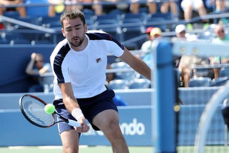 Aug 29, 2016; New York, NY, USA; Marin Cilic of Croatia returns a shot to Roger Dutra Silva of Brazil on Louis Armstrong Stadium on day one of the 2016 U.S. Open tennis tournament at USTA Billie Jean King National Tennis Center. Anthony Gruppuso-USA TODAY Sports