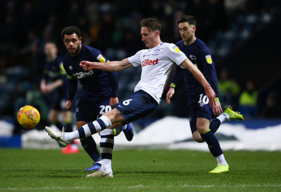 PRESTON, ENGLAND - FEBRUARY 01:  Ben Davies of Preston North End clears from Mason Bennett and Tom Lawrence of Derby County during the Sky Bet Championship match between Preston North End and Derby County  at Deepdale on February 01, 2019 in Preston, England. (Photo by Alex Livesey/Getty Images)