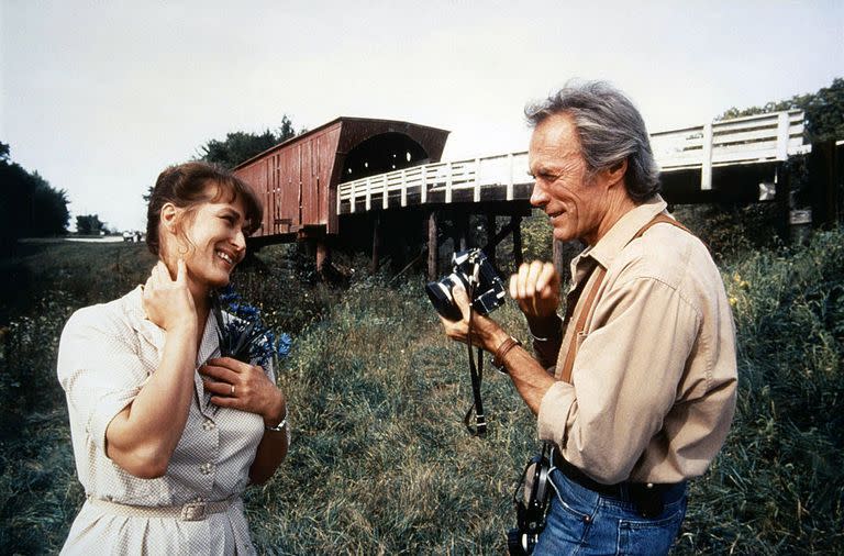 <p>Eastwood and Meryl Streep chat on the set of <em>The </em><em>Bridges of Madison County—</em>a performance that earned Meryl Streep an Oscar nomination for Best Actress.</p>