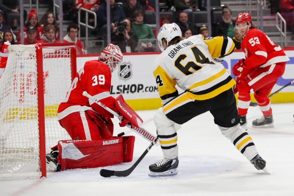 Red Wings goaltender Alex Nedeljkovic saves the shot attempt by Penguins center Mikael Granlund during the first period on Tuesday, March 28, 2023, at Little Caesars Arena.