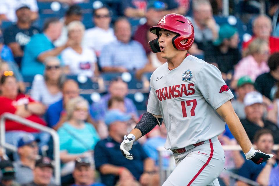 Jun 22, 2022; Omaha, NE, USA; Arkansas Razorbacks designated hitter Brady Slavens (17) reacts after scoring against the Ole Miss Rebels during the fifth inning at Charles Schwab Field. Mandatory Credit: Dylan Widger-USA TODAY Sports