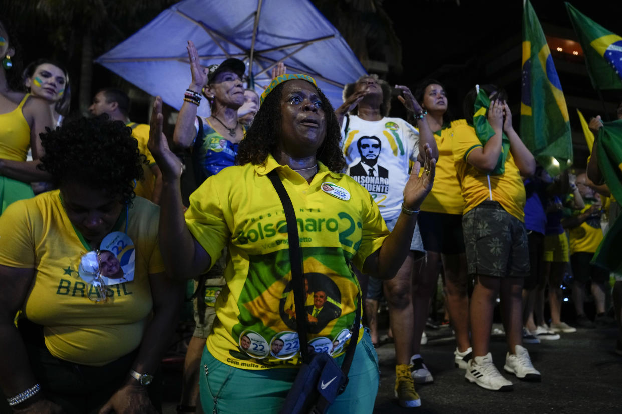 Supporters of Brazilian President Jair Bolsonaro gather after polls closed in a presidential run-off election in Rio de Janeiro, Brazil, Sunday, Oct. 30, 2022. Brazilians had to choose between former President Luiz Inacio Lula da Silva and Bolsonaro, after neither got enough support to win outright in the Oct. 2 general election. (AP Photo/Silvia Izquierdo)