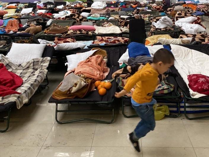 A child plays on Wednesday at the refugee center in the defunct shopping mall.