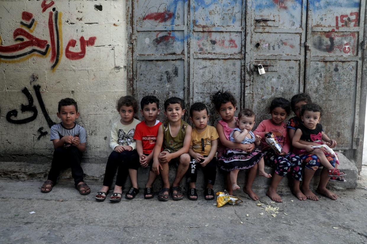 Children sitting near their home at al-Shati camp for Palestinian refugees in the central Gaza Strip on June 20, 2020. <a href="https://www.gettyimages.com/detail/news-photo/girl-carries-a-young-child-near-their-home-at-al-shati-camp-news-photo/1221111213?adppopup=true" rel="nofollow noopener" target="_blank" data-ylk="slk:Majdi Fathi/NurPhoto via Getty Images;elm:context_link;itc:0;sec:content-canvas" class="link ">Majdi Fathi/NurPhoto via Getty Images</a>