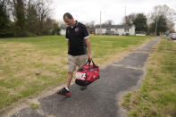 Marco Sanchez walks the streets of Paducah, Ky., on Wednesday, Nov. 22, 2023, after being released from McCracken County Jail. Sanchez risked his life to pull fellow employees from the debris of the Kentucky candle factory which was destroyed by a tornado in 2021 where he was on work release. (AP Photo/Jeff Roberson)