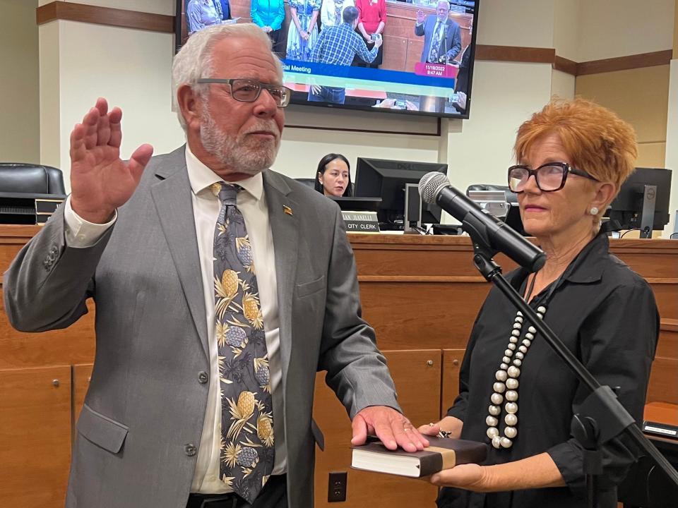 Phil Stokes takes the oath of office to serve as the District 5 representative on the North Port City Commission, with Valerie Sanderson holding the Bible, at a Saturday morning special meeting.