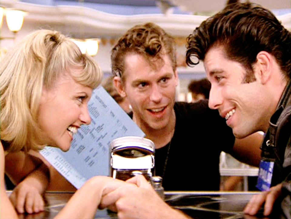 LOS ANGELES - JUNE 16: The movie "Grease", directed by Randal Kleiser. Seen here at the malt shop (from left) Olivia Newton-John as Sandy, Jeff Conaway as Kenickie and John Travolta as Danny Zuko. Initial theatrical release of the film, June 16, 1978. Screen capture. Paramount Pictures. (Photo by CBS via Getty Images)