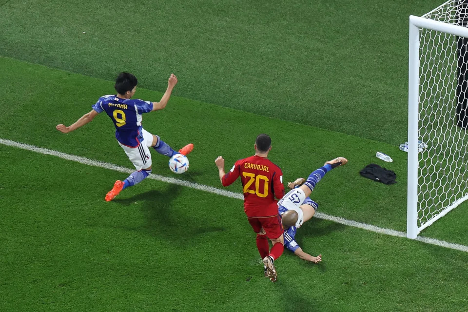 Japan's forward #09 Kaoru Mitoma (L) crosses the ball for his team's second goal during the Qatar 2022 World Cup Group E football match between Japan and Spain at the Khalifa International Stadium in Doha on December 1, 2022. (Photo by Giuseppe CACACE / AFP) (Photo by GIUSEPPE CACACE/AFP via Getty Images)