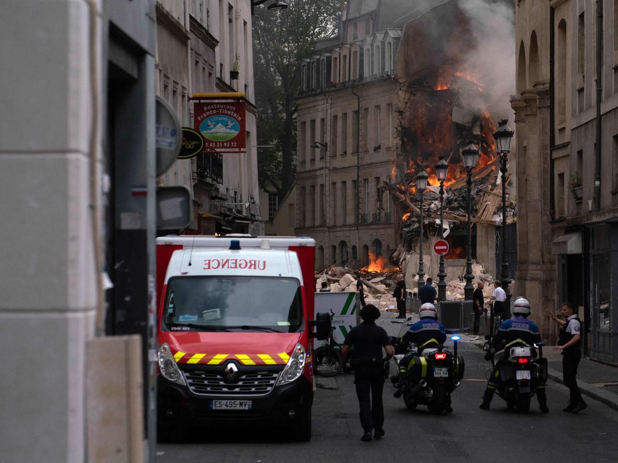 Smoke billows from rubbles of a building at Place Alphonse-Laveran in the 5th arrondissement of Paris (AFP via Getty Images)
