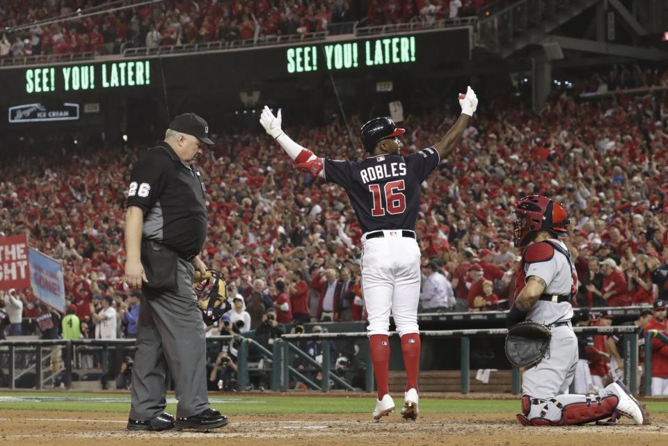 Washington Nationals' Victor Robles reacts as he crosses home after hitting a home run during the sixth inning of Game 3 of the baseball National League Championship Series against the St. Louis Cardinals Monday, Oct. 14, 2019, in Washington. (AP Photo/Jeff Roberson)