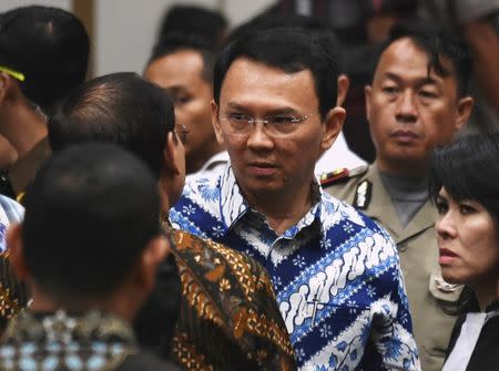FILE PHOTO: Jakarta's Christian governor Basuki Tjahaja Purnama, popularly known as Ahok, speaks to his lawyers after the guilty verdict in his blasphemy trial in Jakarta May 9, 2017. REUTERS/Bay Ismoyo/Pool/File Photo