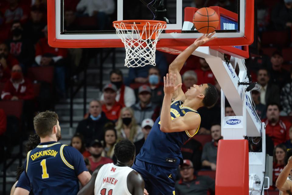 Michigan Wolverines forward Caleb Houstan (22) scores on Nebraska Cornhuskers forward Lat Mayen (11) in the first half at Pinnacle Bank Arena on Dec. 7, 2021.