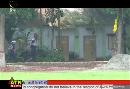 Police walk during a militant attack on Bangladeshi police guarding an Eid festival in Kishoreganj town in this still frame taken from video July 7, 2016. Courtesy of ATN News /via REUTERS TV