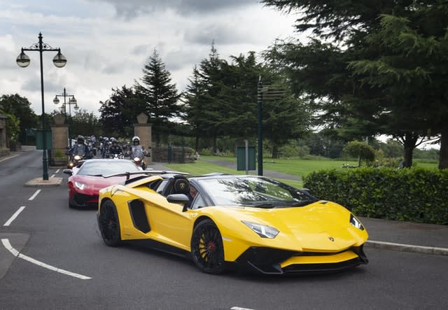 Two Lamborghinis and motorbikes escort the funeral cortege arriving at Grenoside Crematorium, Sheffield, prior to the funeral of Tristan and Blake Barrass