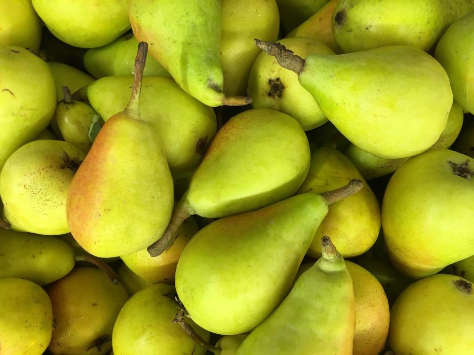 full frame shot of organic raw green pears in market