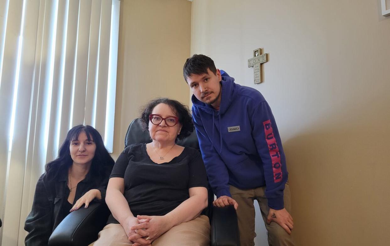 Tamara Heppner, middle, has suffered from radiation-induced necrosis, bleeding and blood clots for nearly three years. But her son Brayden Dutchak, right, says she hasn't been able to access hyperbaric oxygen therapy because the province's only clinic in Moose Jaw was temporarily closed in 2021.  They are pictured here with Heppner's daughter, Shawntae Sharpe. (Submitted by Brayden Dutchak - image credit)