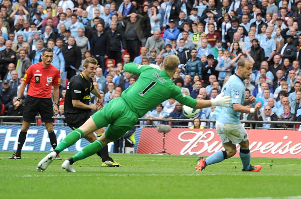 Wigan Athletic's Callum McManaman (left) has a shot blocked by Manchester City's Pablo Zabaleta (right)