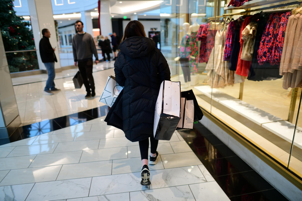 KING OF PRUSSIA, PA - DECEMBER 11: A woman carries bags of purchased merchandise in the King of Prussia Mall on December 11, 2022 in King of Prussia, Pennsylvania. The country's largest retail shopping space, the King of Prussia Mall, a 2.7 million square feet shopping destination with more than 400 stores, is owned by Simon Property Group. (Photo by Mark Makela/Getty Images)