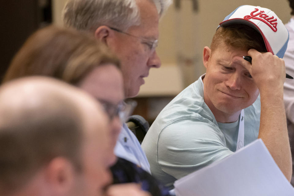 Backup Associate Pronouncer, Christian Axelgard, right, reads through a list of proposed words during a meeting of the word panel to finalize the 2023 Scripps National Spelling Bee words on Sunday, May 28, 2023, at National Harbor in Oxon Hill, Md. (AP Photo/Nathan Howard)