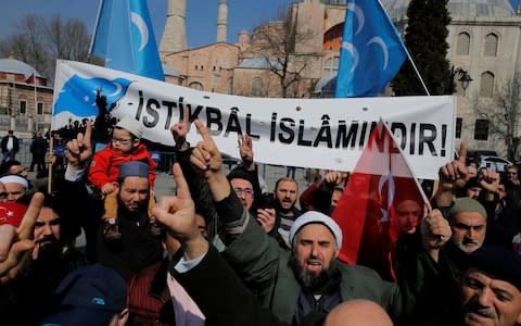 Demonstrators protest in front of the Hagia Sophia against the Christchurch mosque attack in New Zealand. The banner reads: "the future belongs to Islam!" - Credit: REUTERS/Huseyin Aldemir