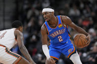 Oklahoma City Thunder guard Shai Gilgeous-Alexander (2) is defended by San Antonio Spurs guard Blake Wesley (14) during the second half of an NBA basketball game in San Antonio, Wednesday, Jan. 24, 2024. (AP Photo/Eric Gay)