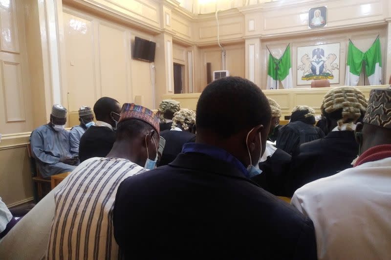 People are seen seated inside a court during a hearing of an appeal case in a blasphemy case in Kano