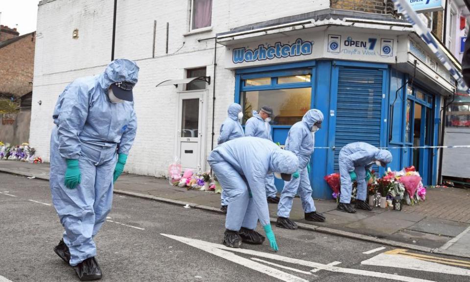Forensic officers search Chalgrove Road in Tottenham, north London, where a 17-year-old girl was shot on Monday evening