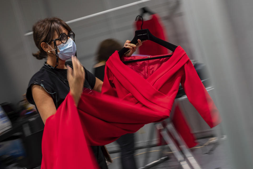 A staffer works at the backstage of Spanish designer Hannibal Laguna a day before the start of the Mercedes-Benz Fashion Week in Madrid, Spain, Wednesday, Sept. 9, 2020. The Spanish fashion will take place from 10 to 13 September under new security measures and social distance guidelines due the coronavirus pandemic. (AP Photo/Bernat Armangue)