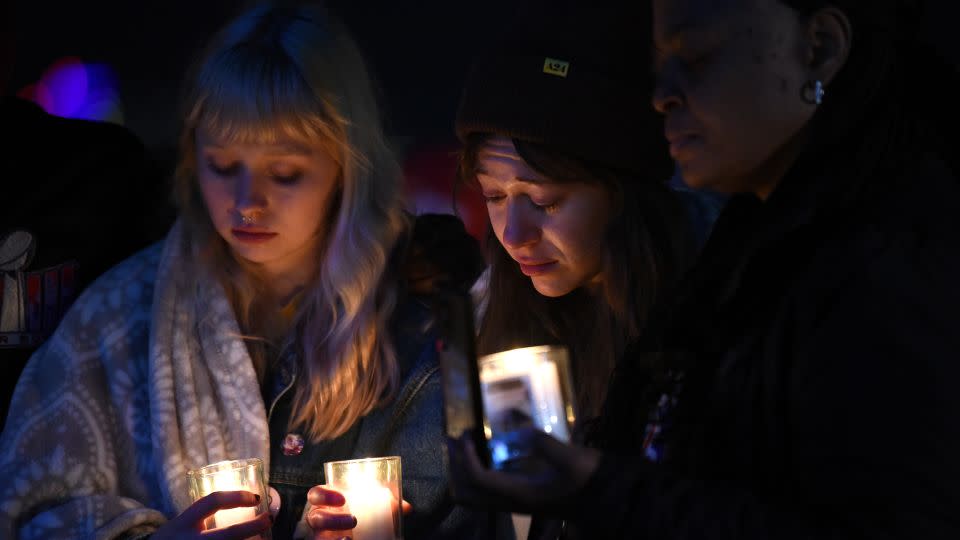Abbey Lewis, left, and Jackie Batista-Martinez, center, at a candlelight vigil in Kansas City. - Emmalee Reed/CNN