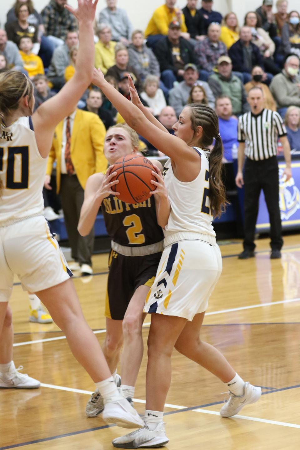 Old Fort's Macie Miller splits two defenders.