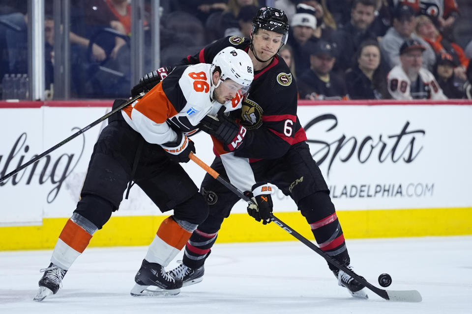 Philadelphia Flyers' Joel Farabee, left, and Ottawa Senators' Jakob Chychrun battle for the puck during the third period of an NHL hockey game, Saturday, March 2, 2024, in Philadelphia. (AP Photo/Matt Slocum)