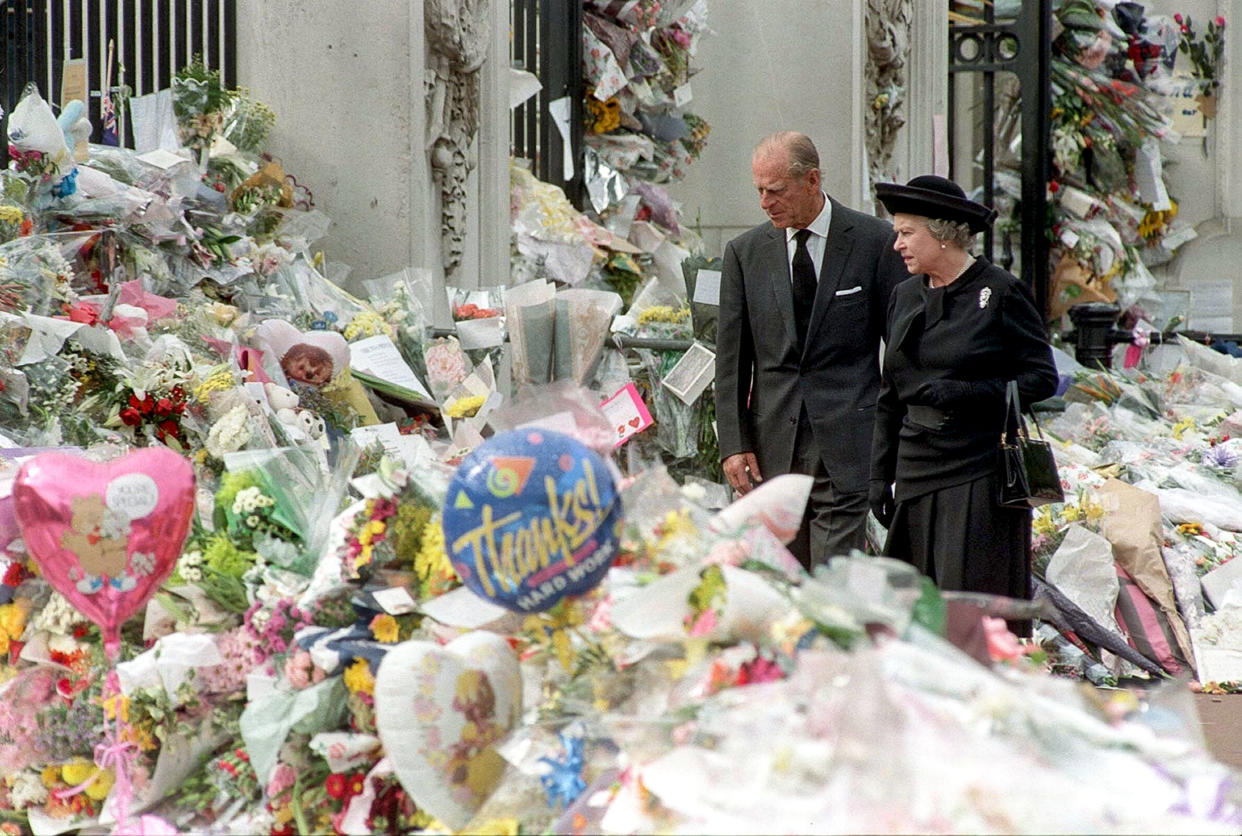 Elizabeth and Philip view the floral tributes to Princess Diana at Buckingham Palace on Sept. 5, 1997, a week after Diana's death. (John Stillwell / AP)