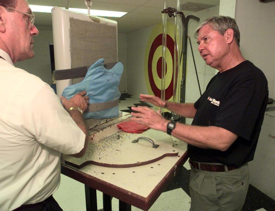 FOR BROWARD 7/2/98 PHOTO BY JOE RIMKUS JR MHS....At Point Blank Body Armor in Oakland Park.Senator Bob Graham doing one of his workdays.Here Bob is looking at a vest he made with David Pisenti,Exec.Vice President of Point Blank Body Armor.He was testing it by shooting 6,9mm rounds into it. JOE RIMKUS JR/MHS