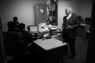 <p>Spencer Leak Sr. consults with his staff before beginning day of funeral visitation and planning. (Photo: Jon Lowenstein/NOOR for Yahoo News) </p>