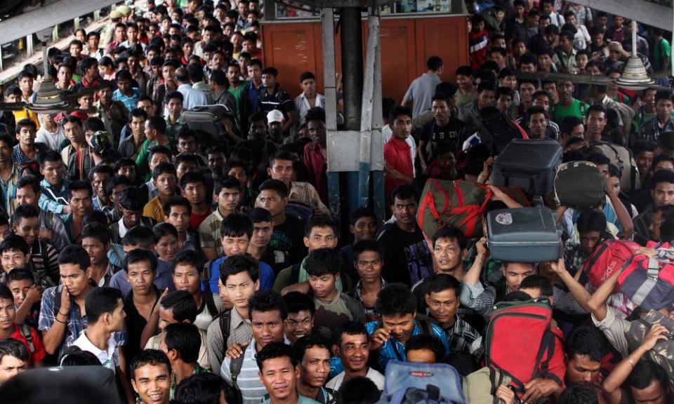 Crowds at a railway station in India. The WHO says the population will peak in 2050 at 1.7bn. 