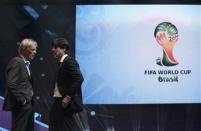 Germany's coach Joachim Low (R) talks to Cameroon's coach Volker Finke during the draw for the 2014 World Cup at the Costa do Sauipe resort in Sao Joao da Mata, Bahia state, December 6, 2013. REUTERS/Ricardo Moraes