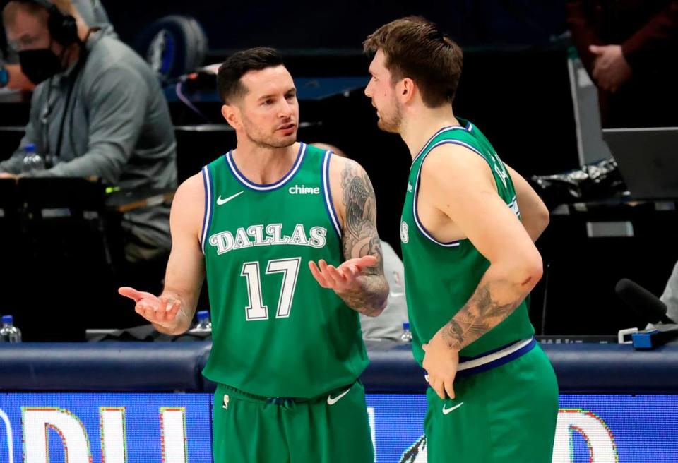Now an ESPN analyst, then-Dallas Mavericks guard JJ Redick speaks with Luka Doncic (right) during a 2021 game.
