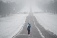 A jogger takes a run in the snow