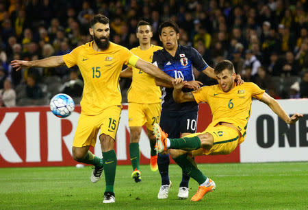 Football Soccer - Australia v Japan - World Cup 2018 Qualifier - Docklands stadium - Melbourne, Australia - 11/10/16. Australia's Matthew Spiranovic and Mile Jedinak in action with Japan's Shinji Kagawa. REUTERS/David Gray