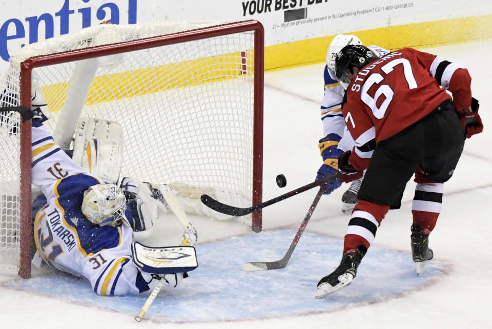 Buffalo Sabres goaltender Dustin Tokarski makes a save on a shot by New Jersey Devils right wing Marian Studenic (67) during the second period of an NHL hockey game Saturday, Oct. 23, 2021, in Newark, N.J. (AP Photo/Bill Kostroun)