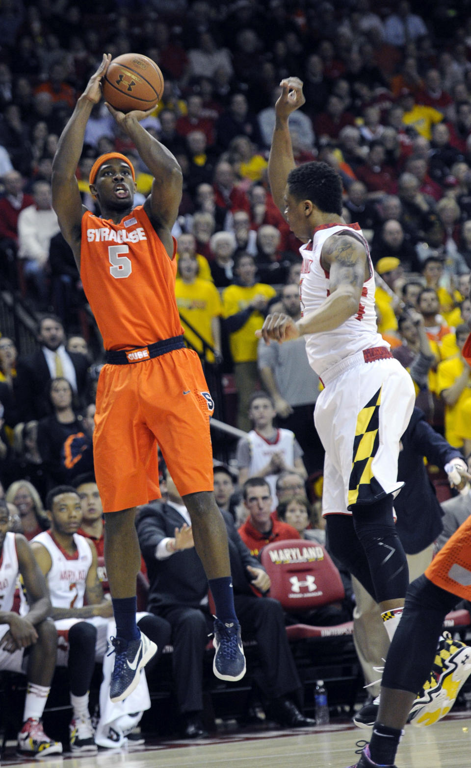 Syracuse forward C.J. Fair (5) shoots against Maryland guard Nick Faust, right, during the first half of an NCAA college basketball game, Monday, Feb. 24, 2014, in College Park, Md. (AP Photo/Nick Wass)