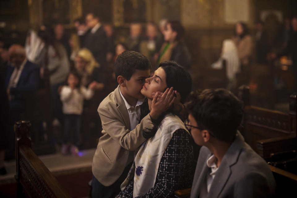 A child hugs a woman as members of the Armenian community attend an Orthodox Easter religious service at the Armenian cathedral in Bucharest, Romania, Saturday, May 4, 2024. (AP Photo/Vadim Ghirda)