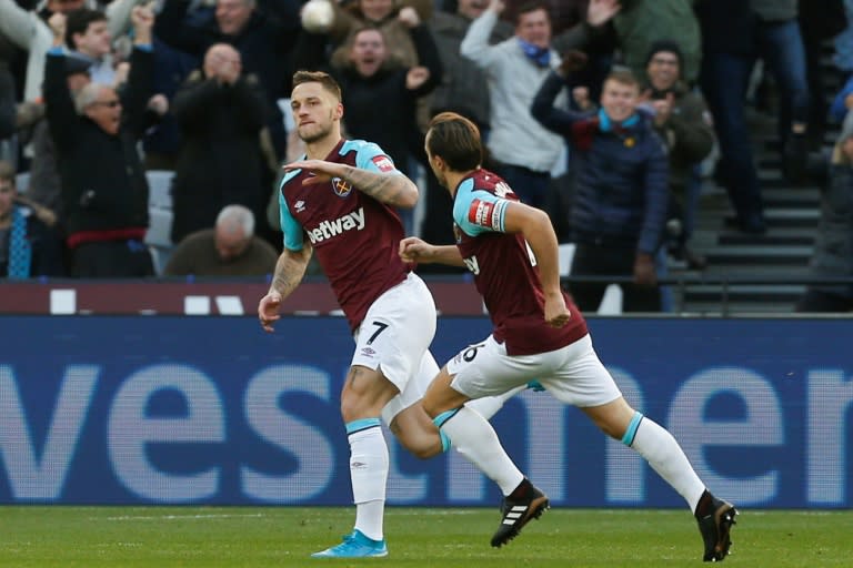 West Ham United's midfielder Marko Arnautovic (L) celebrates with Mark Noble after scoring against Chelsea at The London Stadium, in east London on December 9, 2017