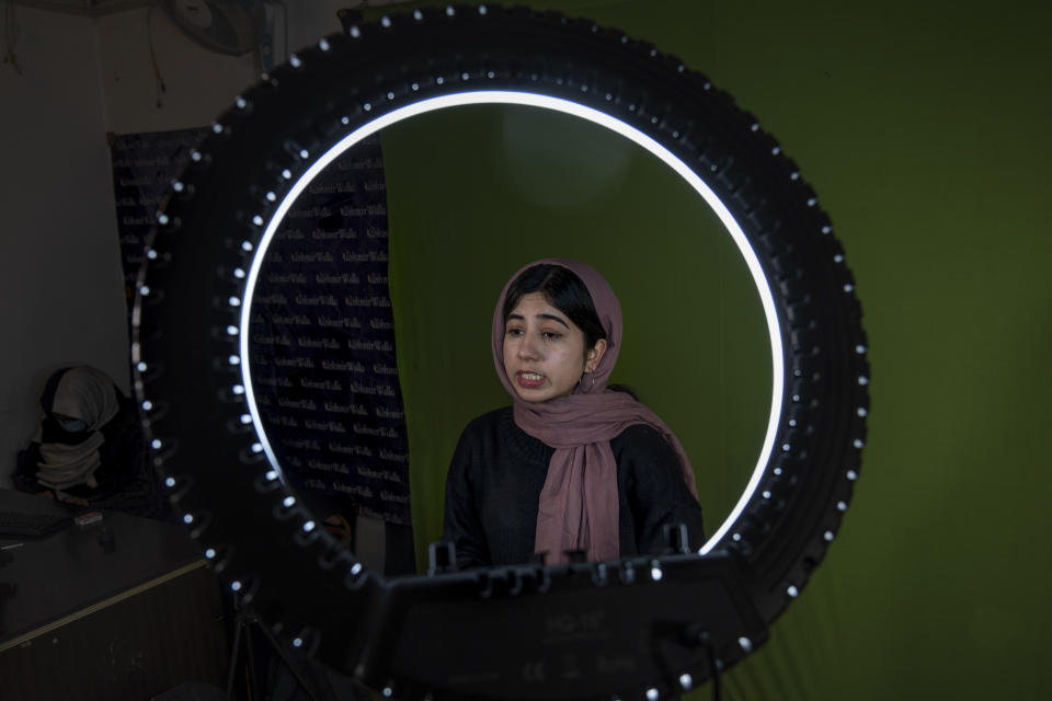 Aleena Mir, a journalist with Kashmir Walla, records the news bulletin inside a studio of her office in Srinagar, Indian controlled Kashmir, Friday, Jan. 21, 2022. Journalists have long contended with various threats in Indian-controlled Kashmir and found themselves caught between warring sides. But their situation has gotten dramatically worse since India revoked the region’s semi-autonomy in 2019, throwing Kashmir under a severe security and communication lockdown and the media in a black hole. A year later, the government’s new media policy sought to control the press more effectively to censure independent reporting. (AP Photo/Dar Yasin)