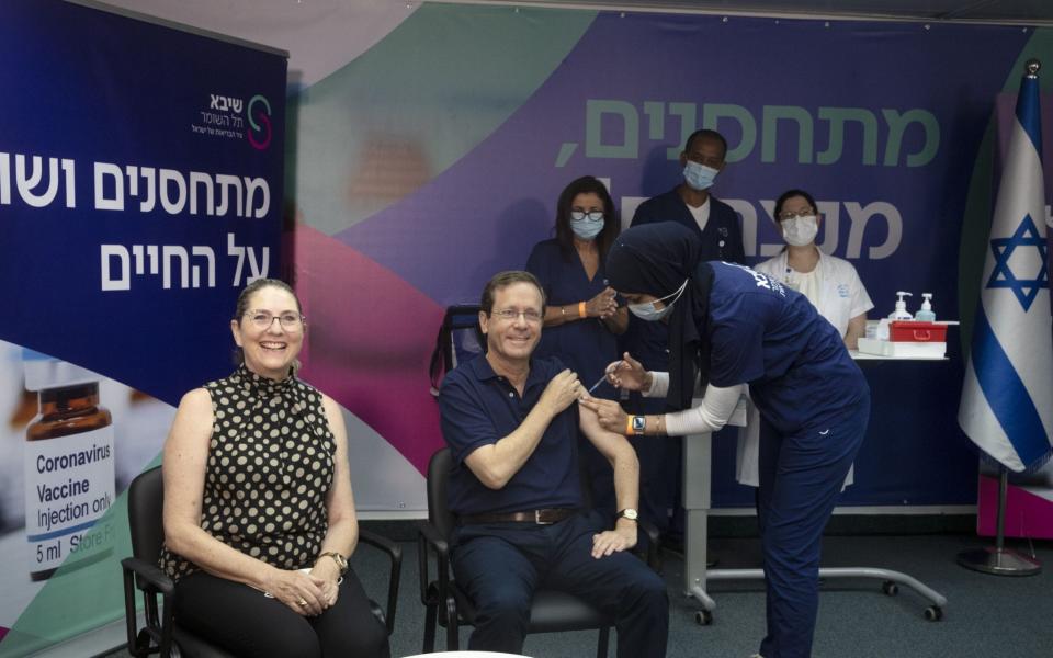 Israeli president Isaac Herzog receives a third dose of the Pfizer Covid-19 vaccine, along with his wife Michal, at Sheba Medical Centre in Ramat Gan, Israel on 30 July 2021 - Maya Alleruzzo/Shutterstock