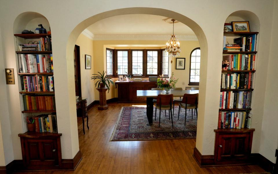 Built-in bookshelves surround the arched door to the dining room at Sarah Frecska's Bay View home.